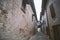 Old narrow alley in tuscan village - antique italian lane in Montalcino, Tuscany, Italy