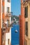 Old narrow authentic street of the city of Villefranche-sur-Mer in the French Riviera resort. View of the sea and yacht.