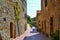 Old, narrow and colored street in San Gimignano, Italy.