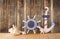 Old nautical wood wheel, anchor and shells on wooden table over wooden background. vintage filtered image