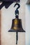 Old naval brass bell. Vintage metal ship`s bell with a rope. Nautical copper ship bell with rope.