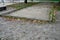 Old neglected playground area rectangular for petanque. wood planked area for playing with metal balls. mostly in public parks thr