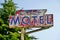 Old Neon Painted Motel Sign with Arrow on Tall Metal Pole