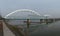 Old and new bridge over the Danube river with tugboat under