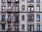 Old New York apartment building with external fire escapes,