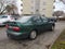 Old Nissan Almera dark green sedan car