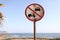 Old No cars no motorbikes sign on the beach and blue sky background on sunny day