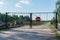 Old no entry for vehicular traffic road sign on rusty fence. Forbidden road or street sign