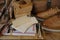 old nostalgic sentimental things, family vintage photographs, stack of books, shoes, leather military satchel on table, checkered