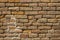 A old not neat red brick wall. rough surface texture. heavily damaged brickwork