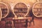 Old oak barrels in an ancient wine cellar.