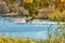 Old oak Leaves With Sunshine Light Flares with Blue River Flow Against Autumn Scenery With Blue Skies on Field of Polesye Natural