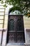 Old oak wood door with colored glass on historical building.