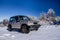 An old offroad car on the snow