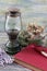 Old oil lamp, book and ceramic on wooden table.