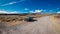 Old Oldsmobile 88 Car in Nevada Desert with blue sky on the horizon