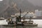 Old Omani fishing vessel in port with Muscat castle