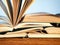 Old open novel books on a wooden table