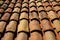 Old orange roof tiles for laying on the roof of the house closeup