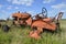 Old orange tractor without rear wheels