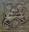 An old ornament of two dancing apsara on the ancient wall with moss, Angkor Wat, Siem Reap, Cambodia