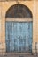 Old ornate wooden doorway painted blue