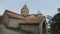 Old orthodox church of stone and brick with tiled roof and high towers, highlands of Georgia