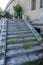 Old overgrown with destroyed stone balustrades old antique steps of a stone staircase. Ruined stairs. The dilapidated building,