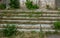 Old overgrown with destroyed stone balustrades old antique steps of a stone staircase. Ruined stairs. The dilapidated building,