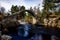 Old Pack Horse Bridge over the milky water of River Dulnain at Carrbridge on Speyside, Scotland