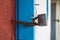 Old padlock iron lock on a wooden door, close-up