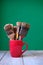 Old paintbrushes inside red cup