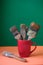 Old paintbrushes inside red cup