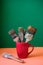 Old paintbrushes inside red cup