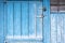 Old painted blue wooden door to the old barn. Blue wooden door w