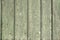 Old painted green faded wood fence background