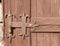 Old painted handmade hinge on wooden door, Bulgaria