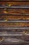 Old painted peeled off dark brown wood background planks texture