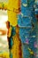 Old painted stairs in the playground close-up on a blurred background. peeling blue and yellow paint. many layers of paint on a