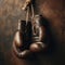 Old pair of boxing gloves, hanging against a distressed wall