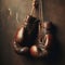 Old pair of boxing gloves, hanging against a distressed wall