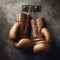 Old pair of boxing gloves, hanging against a distressed wall