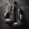 Old pair of boxing gloves, hanging against a distressed wall