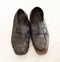 Old pair of Mens leather black dress shoes that are worn out, very dusty and dirty and falling apart.  They need polish and repair