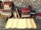 Old paper and ancient books on study table in medieval scene