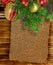 Old paper, christmas branch and decorations on wooden background. Sheet of old paper for text