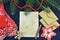 Old paper sheet with post envelope, knitted mittens and evergreen conifer on table. Wish letter to Santa concept with copy space