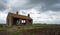 Old partly scrapped building under threatening storm clouds