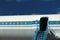 Old passenger aircraft door and windows against blue sky background