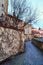 Old paved street with ivy-covered wall. Znojmo, Czech Republic.